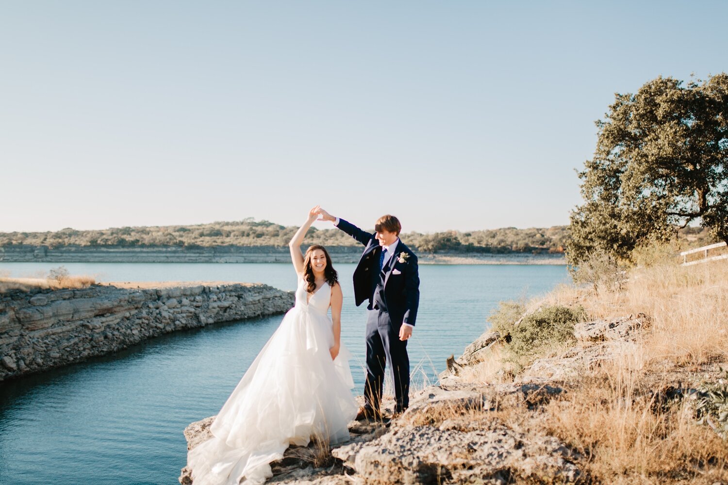 A couple on the rocky shore of the private cove